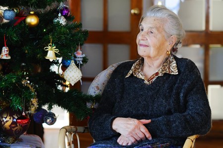 Grey haired lady with Xmas tree.jpg
